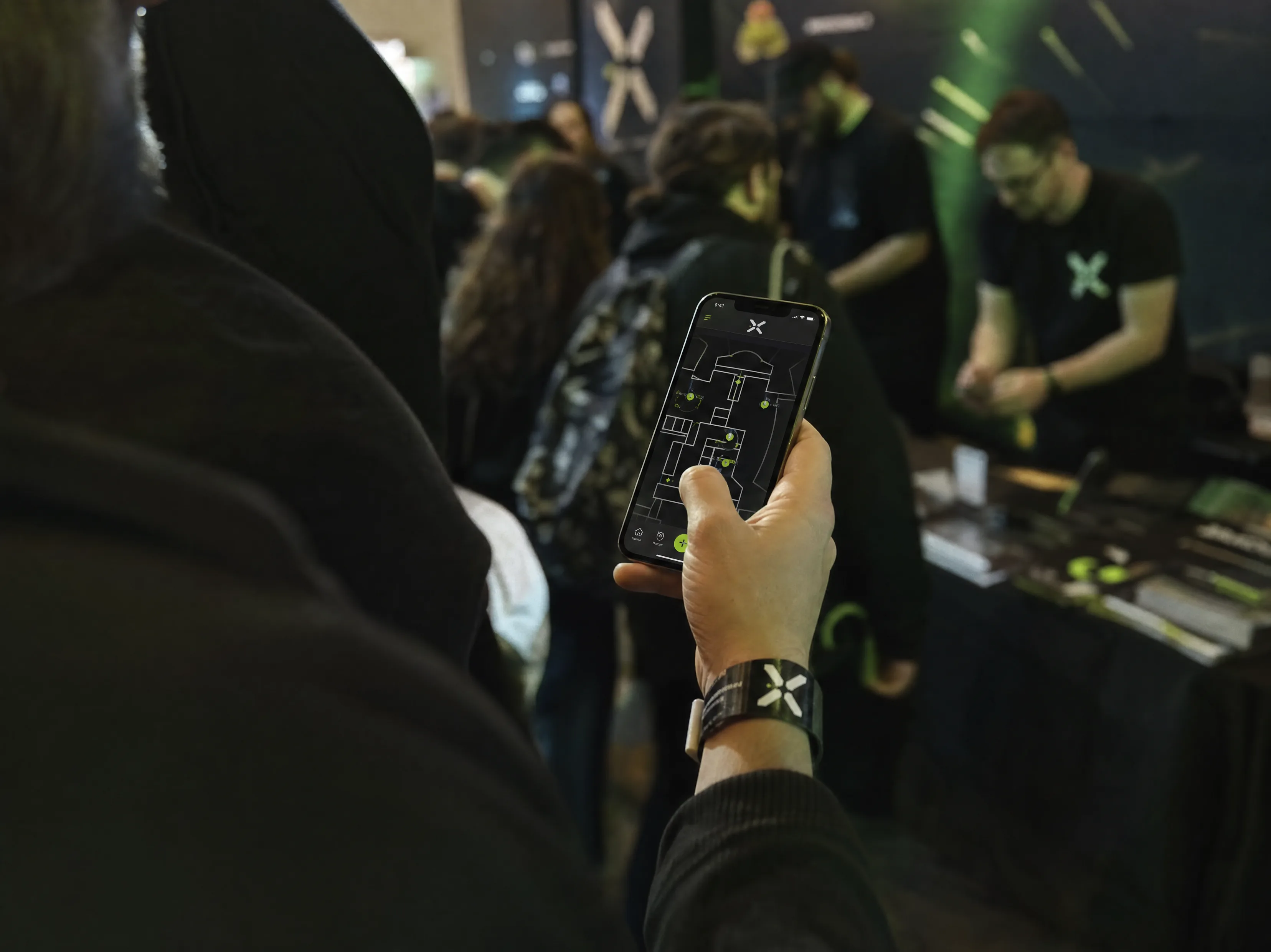 Guest checking the event map on mobile in a live crowd